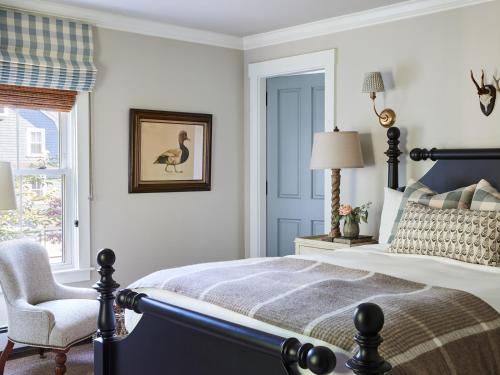 a bedroom with a bed and a chair and a window at The White Barn Inn & Spa, Auberge Collection in Kennebunk