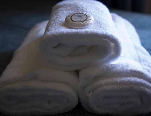 a white towel with a button on top of it at The Maisonette in Sydney