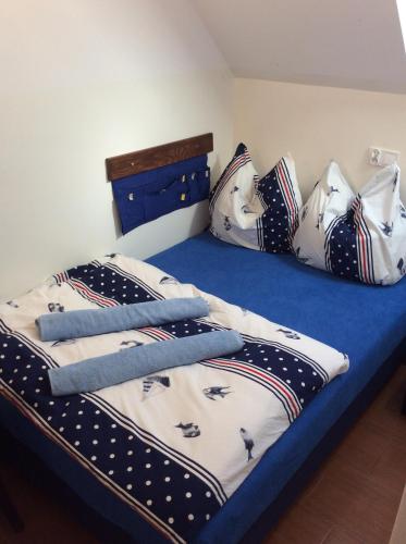 a bed with black and white blankets and pillows at Casa del Mar free Parking Only Adults for Young U45yrs in Międzyzdroje