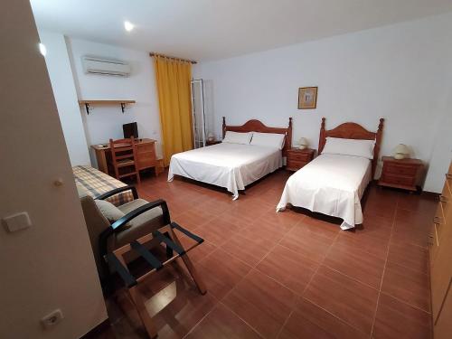 a room with two beds and a table and a couch at Can Panxeta in Pallaresos