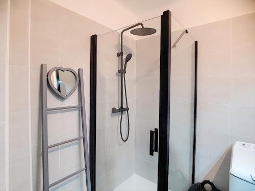a shower with a glass door and a mirror at ROOFTOP#PLAGES#APERCU MER#CLIM#Festival in Cannes