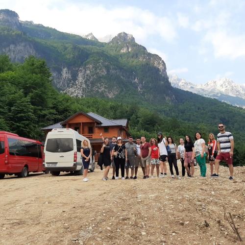 a group of people standing in front of a mountain at Bujtina Malaj in Valbonë