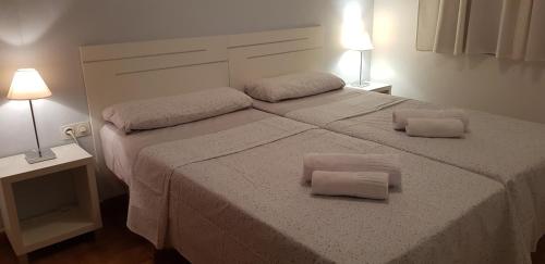 a bedroom with a large bed with two pillows on it at Casa MALIBU in Son Bou