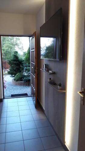 a hallway with a door leading to a patio at Apartament Kapi in Kalwaria Zebrzydowska
