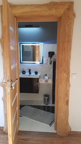 a bathroom with a sink and a mirror at Domek u Bizioma in Murzasichle