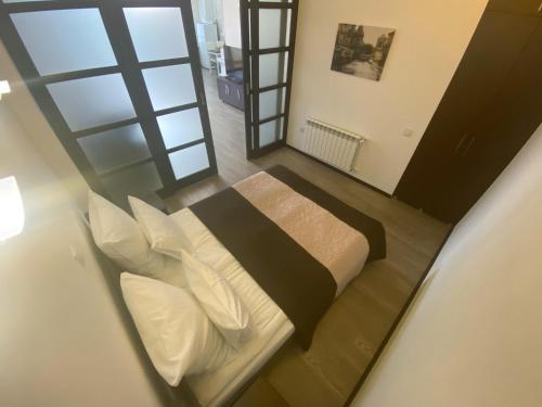 a bedroom with a bed and a large window at Studio with separate bed room in Truskavets
