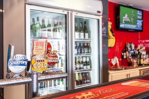 a refrigerator filled with lots of bottles of beer at Sunshine Motor Inn in Ardeer