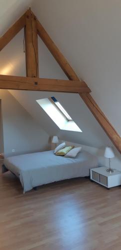 een slaapkamer met een bed op zolder bij Le hameau in Duneau