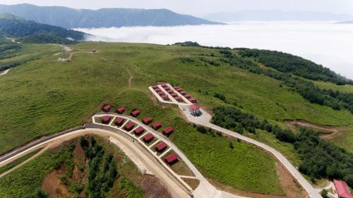 an aerial view of a train on a hill at Flora Handüzü Resort Bungalow in Rize