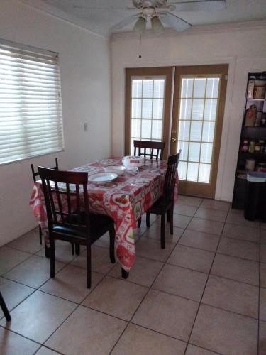 a dining room with a table and chairs and windows at Home Sweet Home in Colton