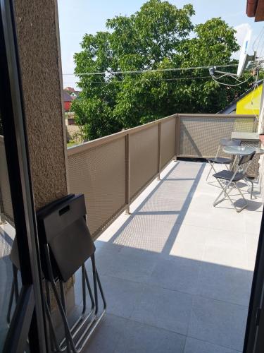 a view of a balcony with a table and chairs at Alisa Apartments in Kostomlaty