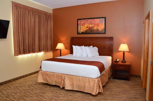 a hotel room with a large bed and two lamps at Cobblestone Inn & Suites - Newton in Newton