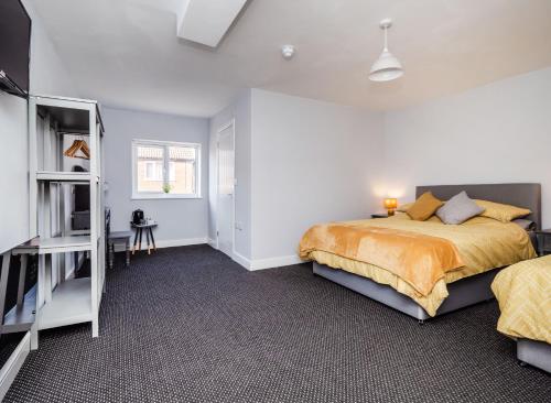 a bedroom with a bed and a book shelf at Rooms at number 4 in North Walsham
