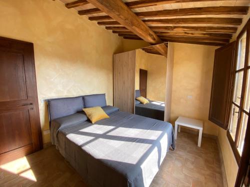 a bedroom with a blue bed in a room at Tuscany Charme Boutique House in Monteroni dʼArbia