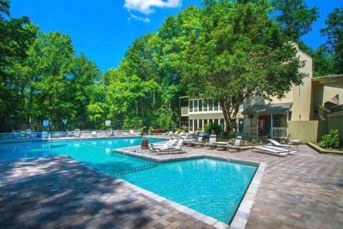 a large swimming pool with chairs and trees at Million Dollar Views! 4 Bedroom, Sleeps 9, close to National Park and 5 mi to Gatlinburg! in Gatlinburg