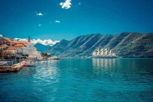 a view of a body of water with mountains at Apartments Dragišić in Sveti Stefan