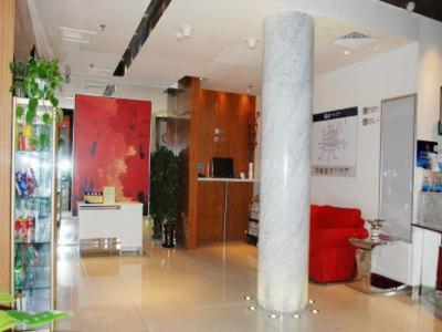 a room with a pillar and a red couch in it at Jinjiang Inn Select Beijing Pingguoyuan Metro Station in Beijing