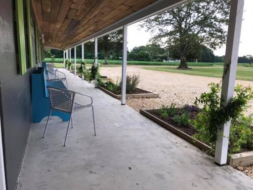 a row of chairs sitting on a porch at The Quarters at Pier450 in Lexington Park