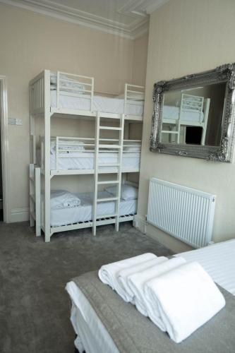 a room with two bunk beds and a mirror at The Kings Cross Hotel in Blackpool