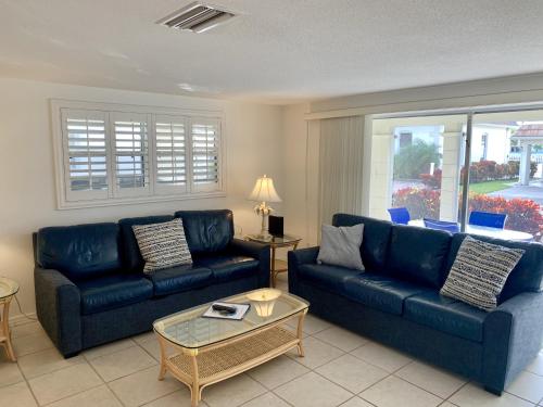 a living room with two blue couches and a table at Island House Beach Resort 9 in Siesta Key