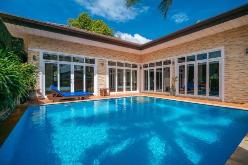 a swimming pool in a house with a large swimming pool at Rawai Private Villas - Pools and Garden in Rawai Beach