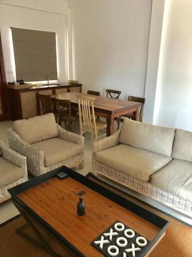 a living room with a couch and a table at Iddamal Apartments in Mount Lavinia