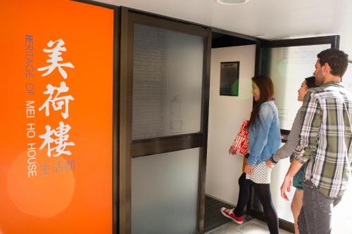 a group of people standing in a room at YHA Mei Ho House Youth Hostel in Hong Kong