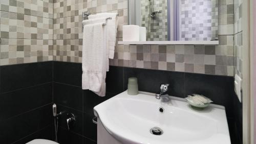 a bathroom with a white sink and a toilet at Royal Dante in Naples
