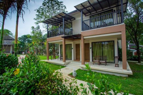 a house with a balcony on top of it at The Leaf on The Sands by Katathani - SHA Extra Plus in Khao Lak