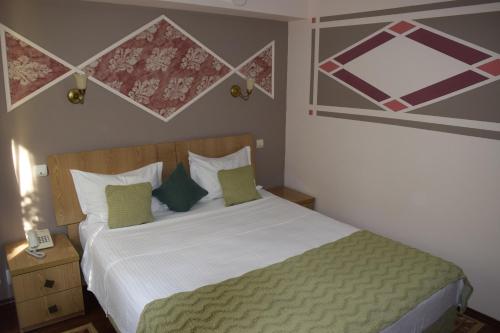 Postel nebo postele na pokoji v ubytování Hotel Michelangelo