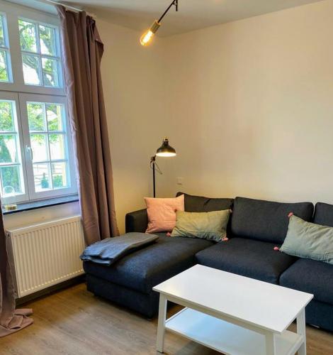 a living room with a couch and a table at Ferienwohnungen Georgenbruch in Everswinkel
