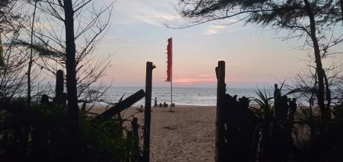 a view of a beach with a flag in the distance at OmBodhi Retreat in Kumta