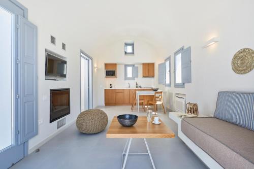 a living room with a couch and a table at Nova Luxury Suites in Pirgos