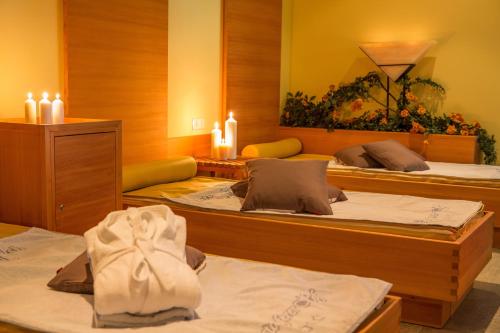 a room with three beds with candles on them at Langtaufererhof in Melago