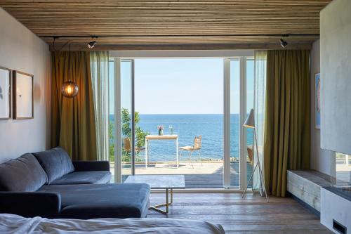 a living room with a couch and a view of the ocean at Nordlandet in Allinge