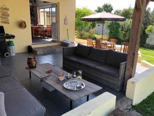 a living room with a couch and a table at A Casa Amarela in Pinheiro de Coja