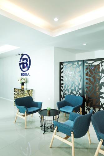 a waiting room with blue chairs and a table at B Hotel in Khon Kaen