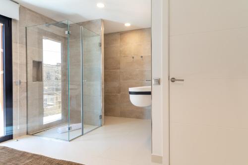 a bathroom with a glass shower and a sink at Mont Blau in Búger