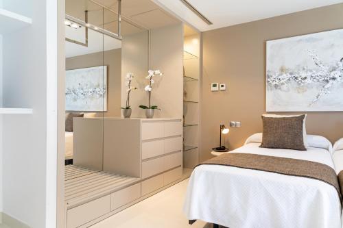 a bedroom with a bed and a mirror at Mont Blau in Búger
