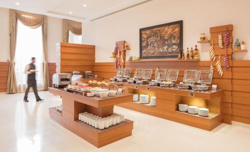 una persona caminando en una habitación con una exhibición de comida en Orchha Palace and Convention Centre, en Orchha