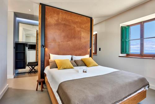 a bedroom with a large bed with a wooden headboard at Lighthouse on La Palma Island in Barlovento