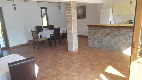 a kitchen and dining room with a table and chairs at Escape in Dubova