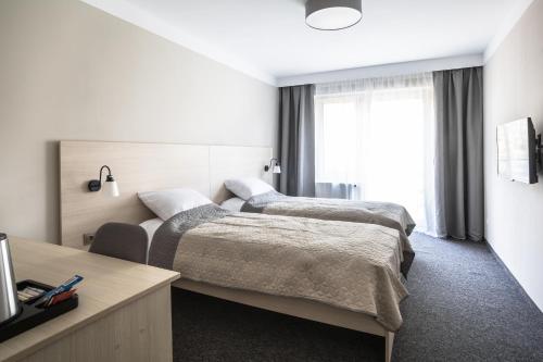 מיטה או מיטות בחדר ב-Blis Apartamenty