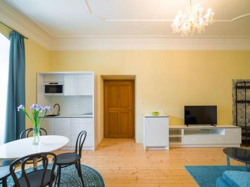 a kitchen and a living room with a table and chairs at NA KNÍŽECÍ CESTĚ VALTICE in Valtice
