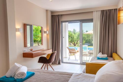 a hotel room with two beds and a balcony at Alonaki Resort in Preveza