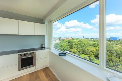 a kitchen with a large window with a view at STAY Bryggen in Copenhagen