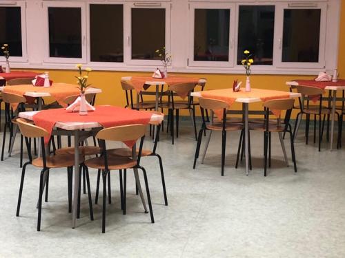 a room with tables and chairs with flowers on them at Ryś Słoneczna Góra in Karpacz