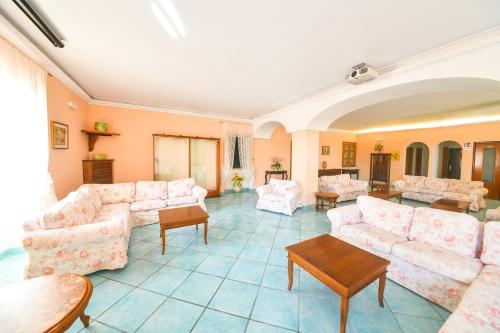 a large living room with couches and tables at Hotel Maremonti in Ischia