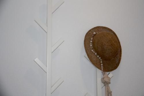 a hat is hanging on a wall next to a clock at Holiday apartment Amatista in Calpe