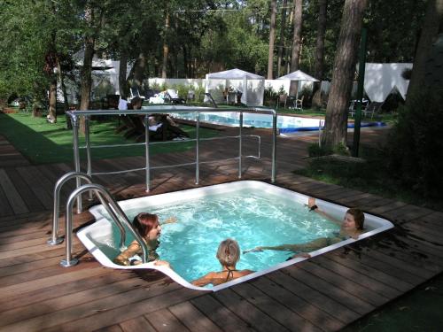 a group of people in a jacuzzi in a pool at SPA Hotel in Vorzelʼ